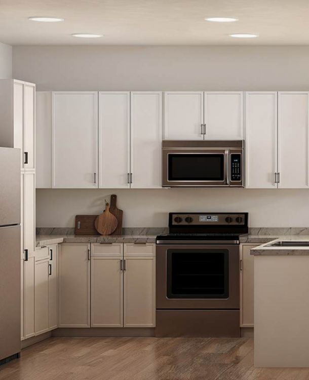 Bright kitchen and living area at Linden Village featuring modern cabinetry, stone countertops, and warm wood-style flooring.