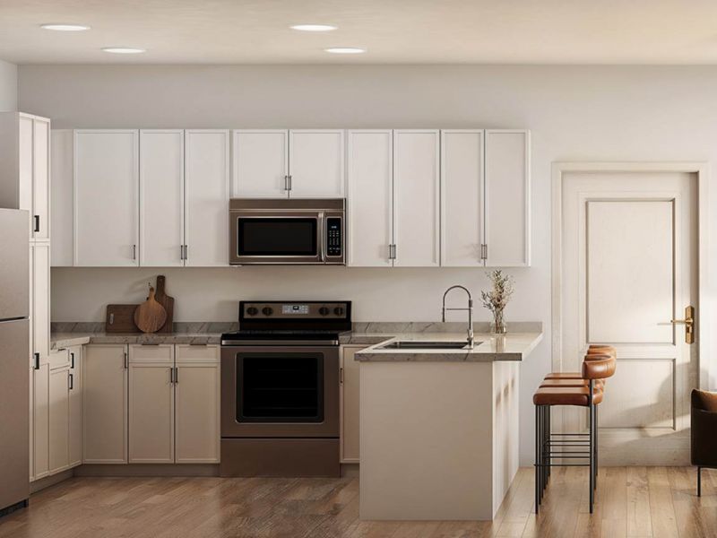 Bright kitchen and living area at Linden Village featuring modern cabinetry, stone countertops, and warm wood-style flooring.